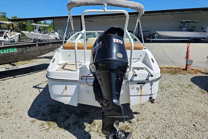 Slide: The Image of 2019 Caravelle 17 EBo Bowrider with Suzuki 115 outboard motor, parked outdoors. - 8