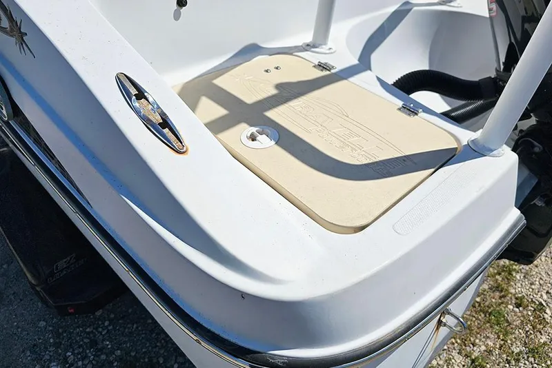 Slide: The Image of 2019 Caravelle 17 EBo Bowrider boat stern detail with logo and storage hatch. - 9