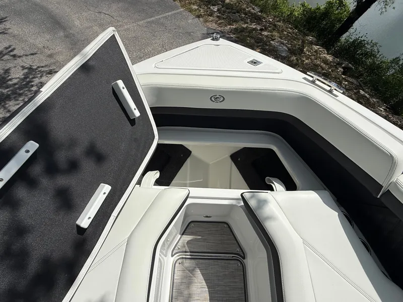 Slide: The Image of Cobalt R4 2025 boat with open storage compartment by the lake. - 10