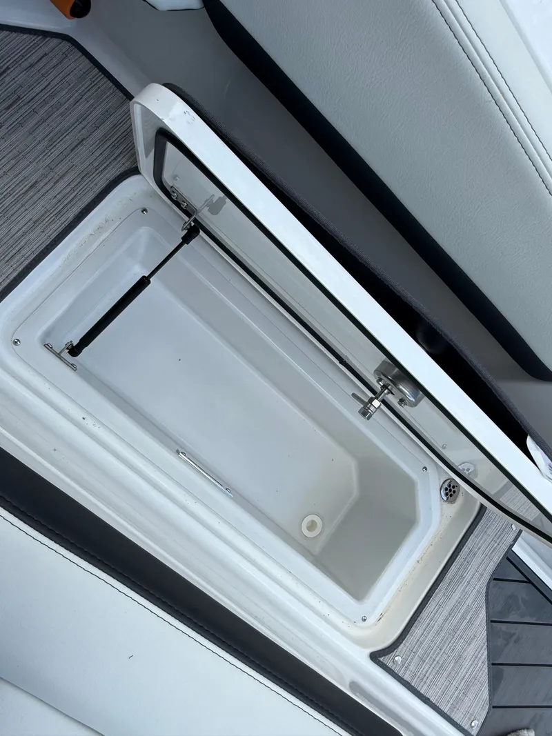 Slide: The Image of Open storage compartment in Cobalt R4 boat, model 2025. - 18