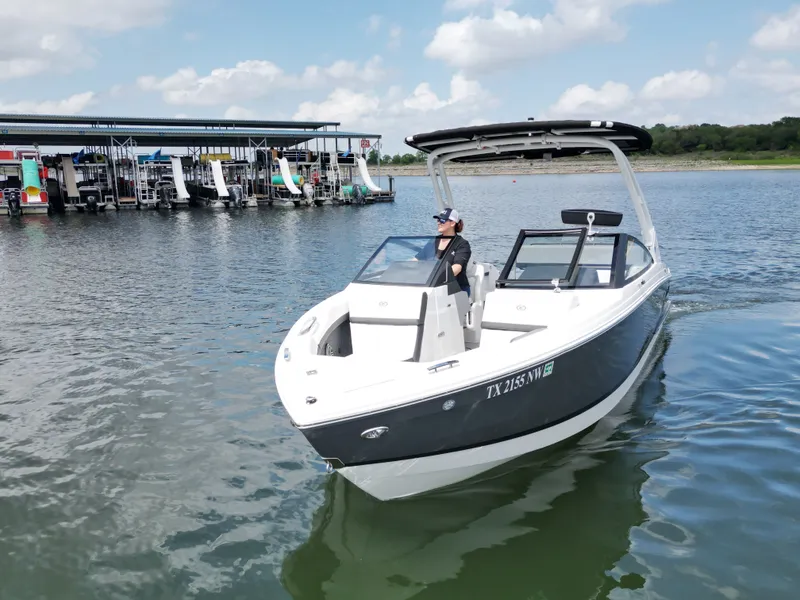 Slide: The Image of 2025 Cobalt R4 boat on calm water with marina in background. - 21