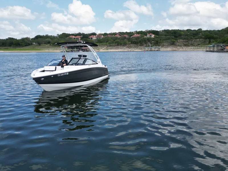 Slide: The Image of Cobalt R4 2025 boat on calm lake with cloudy sky. - 22