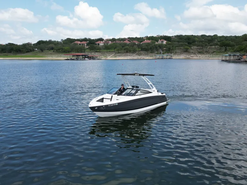 Slide: The Image of Cobalt R4 2025 boat on a calm lake with cloudy sky. - 23