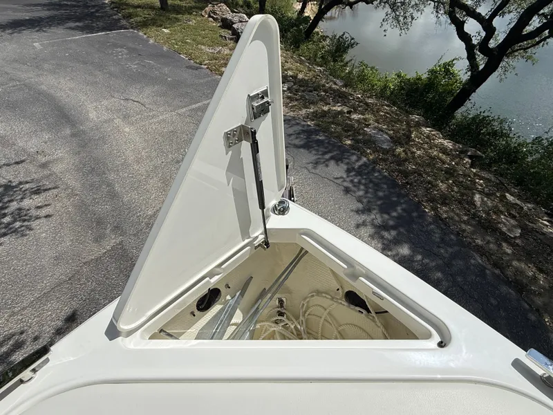Slide: The Image of Open storage compartment in the bow of a 2025 Cobalt R4 boat. - 9