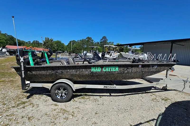 The Image of 2020 Xpress XP200 Catfish boat on trailer, outdoors under clear blue sky. - 1
