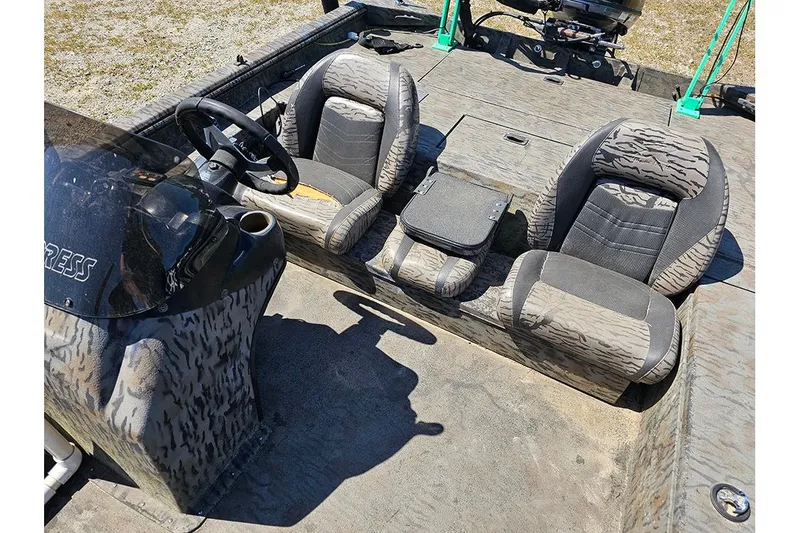 Slide: The Image of 2020 Xpress XP200 Catfish boat interior with camouflage seats and steering console. - 10