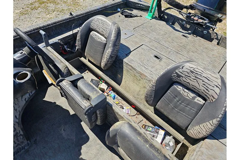 Slide: The Image of 2020 Xpress XP200 Catfish boat interior with camo seats and storage compartments. - 12