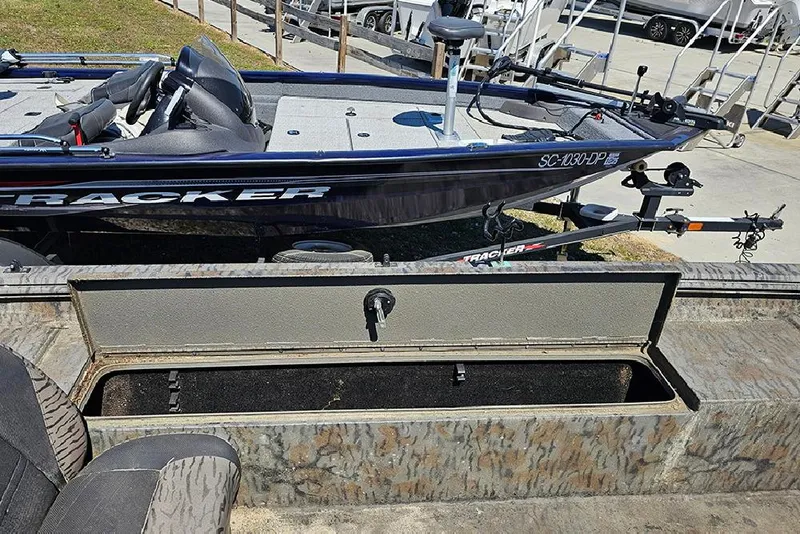 Slide: The Image of 2020 Xpress XP200 Catfish boat with open storage compartment, parked on trailer. - 14