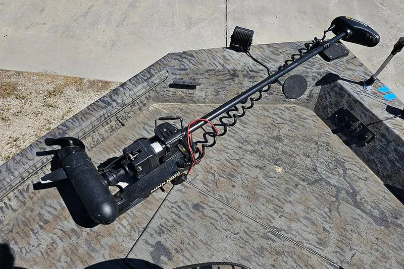 Slide: The Image of Trolling motor on 2020 Xpress XP200 Catfish boat deck, featuring camo pattern. - 18