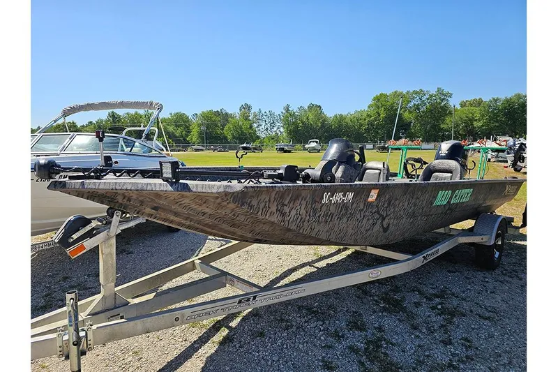 Slide: The Image of 2020 Xpress XP200 Catfish boat on trailer, parked outdoors under clear blue sky. - 5