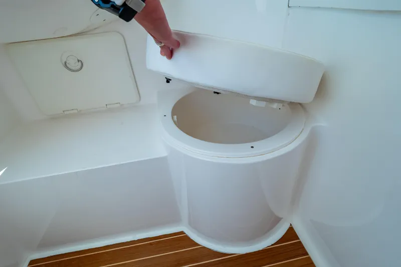 Slide: The Image of 2014 Intrepid 375 Walkaround boat toilet with wooden flooring. - 100