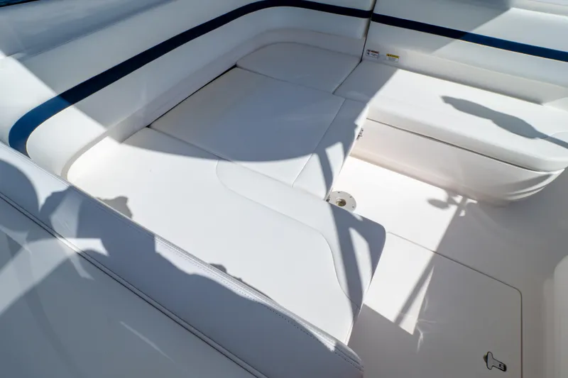 Slide: The Image of Interior seating of 2014 Intrepid 375 Walkaround boat, featuring white upholstery and blue accents. - 101