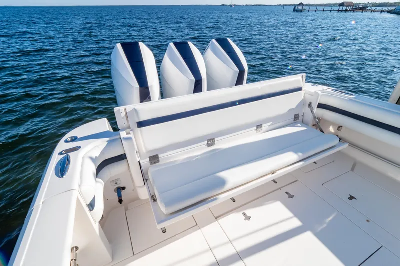 Slide: The Image of 2014 Intrepid 375 Walkaround boat with triple engines and foldable seating, on open water. - 103
