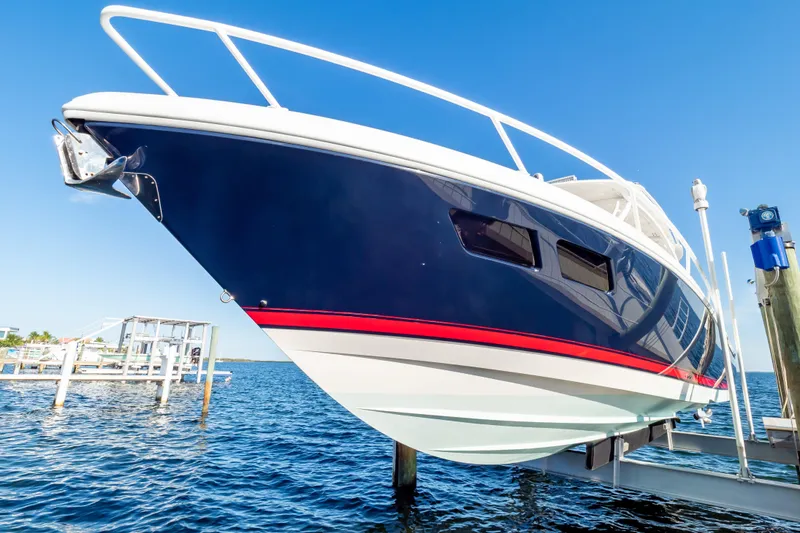 Slide: The Image of 2014 Intrepid 375 Walkaround boat docked on a sunny day. - 104
