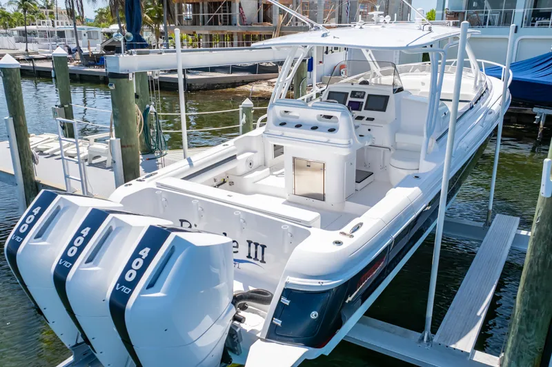 Slide: The Image of 2014 Intrepid 375 Walkaround boat with triple 400 V10 engines docked at marina. - 107