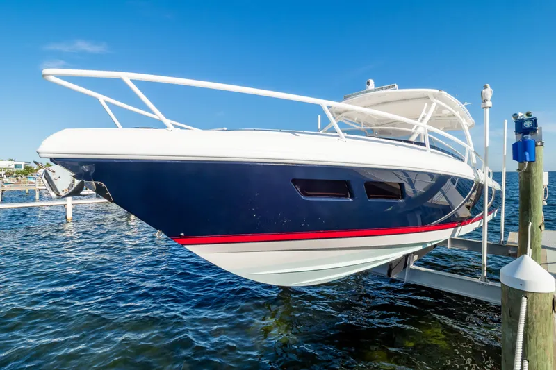 Slide: The Image of 2014 Intrepid 375 Walkaround boat docked on a sunny day, featuring sleek design and vibrant colors. - 109