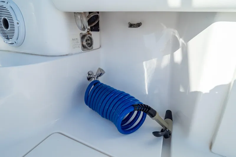 Slide: The Image of Coiled blue hose in 2014 Intrepid 375 Walkaround boat interior. - 112