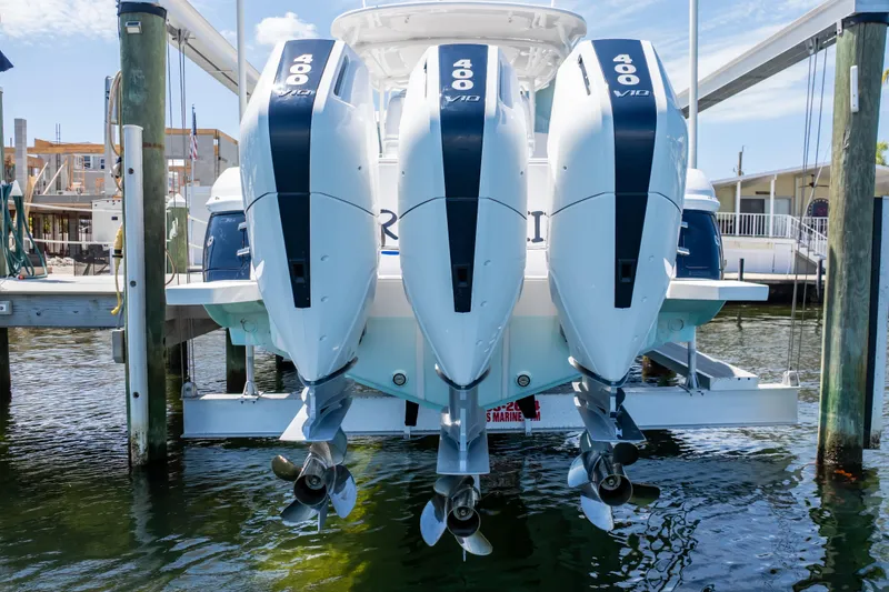 Slide: The Image of Triple outboard engines on a 2014 Intrepid 375 Walkaround boat at a dock. - 114