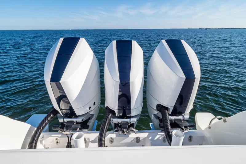 Slide: The Image of Triple outboard engines on a 2014 Intrepid 375 Walkaround boat, ocean backdrop. - 115