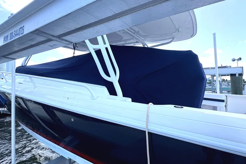 Slide: The Image of 2014 Intrepid 375 Walkaround boat docked with cover, side view. - 118
