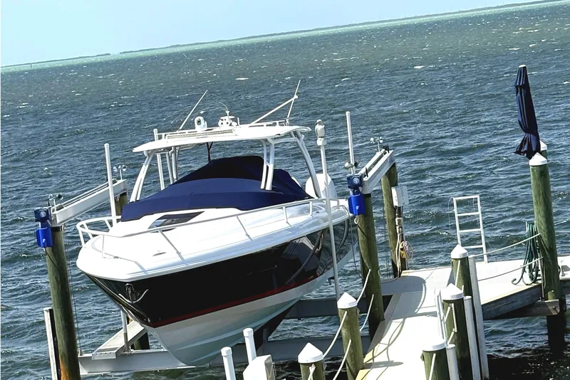 Slide: The Image of 2014 Intrepid 375 Walkaround boat docked on a sunny day. - 120