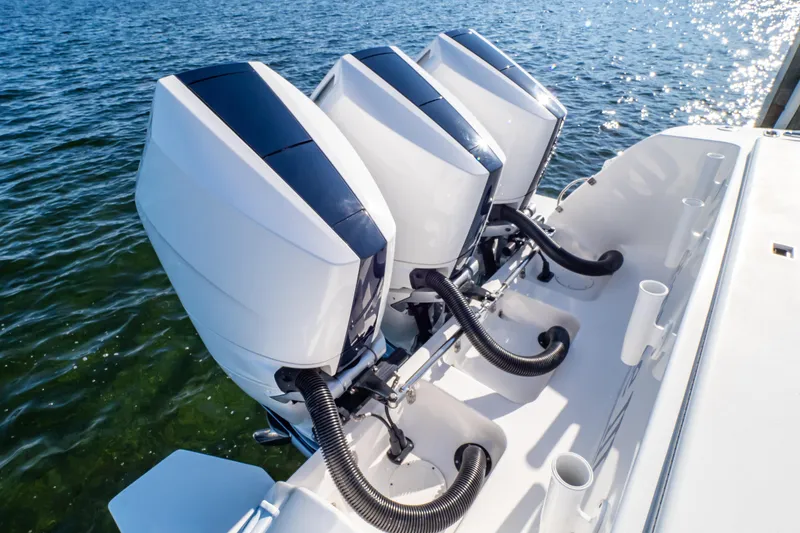 Slide: The Image of Triple outboard engines on a 2014 Intrepid 375 Walkaround boat, cruising on clear water. - 15