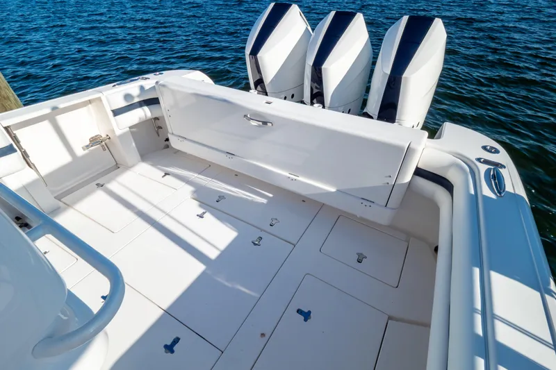 Slide: The Image of 2014 Intrepid 375 Walkaround boat deck with triple outboard engines on water. - 16