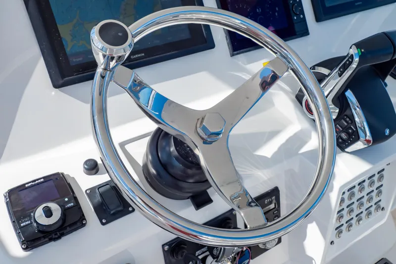 Slide: The Image of Steering wheel and controls of a 2014 Intrepid 375 Walkaround boat cockpit. - 19