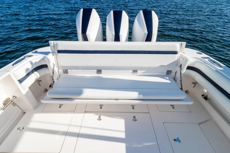 Slide: The Image of 2014 Intrepid 375 Walkaround boat with triple engines and spacious seating on open water. - 2