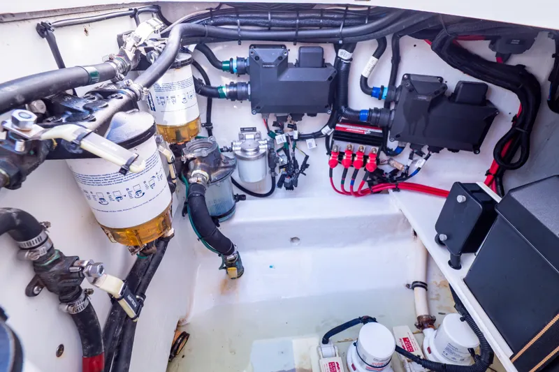 Slide: The Image of Engine compartment of a 2014 Intrepid 375 Walkaround boat, showcasing fuel filters and wiring. - 29