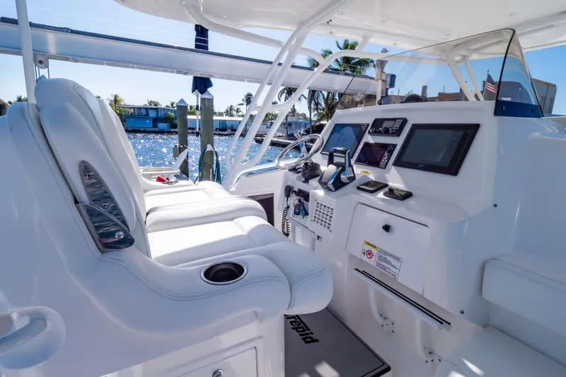 Slide: The Image of 2014 Intrepid 375 Walkaround boat interior with modern helm and white seating. - 3