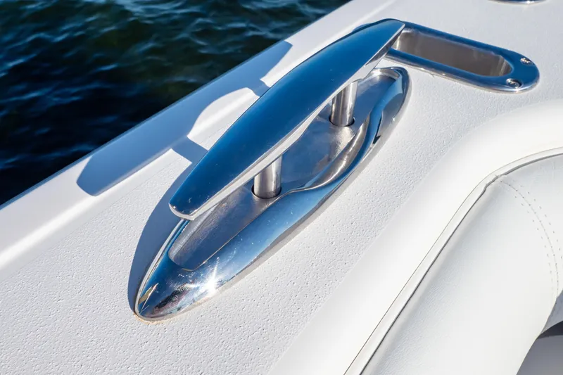 Slide: The Image of Chrome cleat on 2014 Intrepid 375 Walkaround boat, against a backdrop of water. - 33