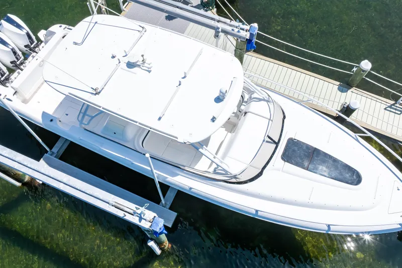 Slide: The Image of Overhead view of a 2014 Intrepid 375 Walkaround boat docked in clear water. - 34
