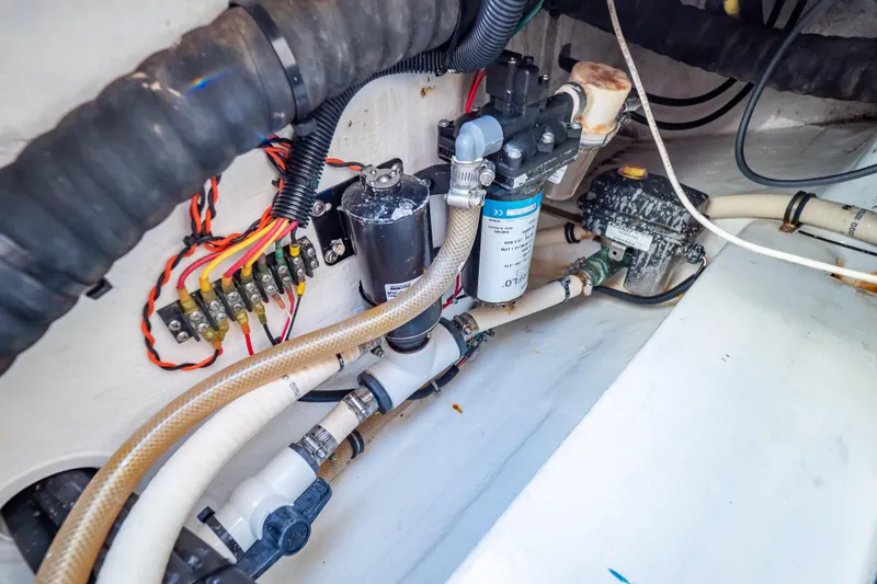 Slide: The Image of Engine compartment of a 2014 Intrepid 375 Walkaround boat, showcasing wiring and plumbing. - 35