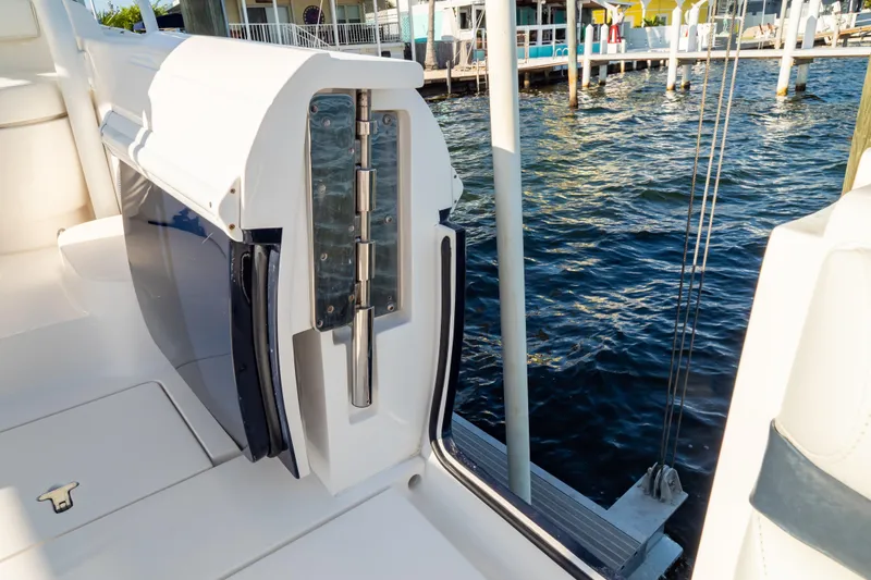 Slide: The Image of 2014 Intrepid 375 Walkaround boat detail with open hatch by waterfront dock. - 39