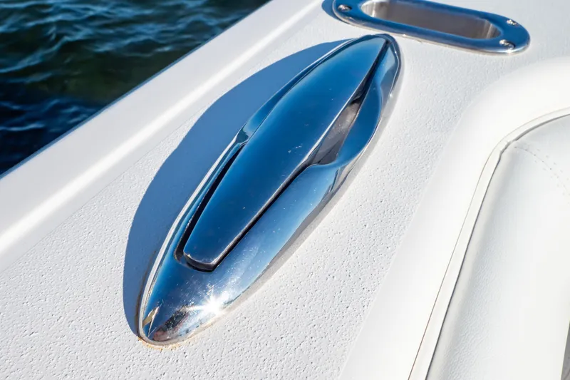 Slide: The Image of Chrome cleat on 2014 Intrepid 375 Walkaround boat deck by the water. - 40