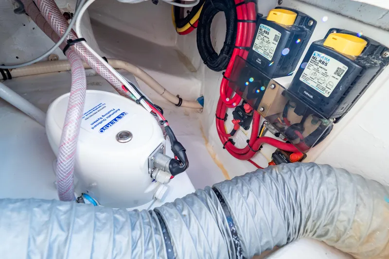 Slide: The Image of Electrical system components inside a 2014 Intrepid 375 Walkaround boat, featuring wiring and switches. - 44