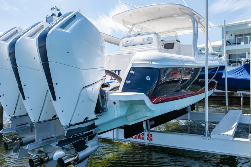 Slide: The Image of 2014 Intrepid 375 Walkaround boat with triple outboard engines on a lift. - 46