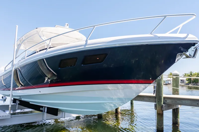 Slide: The Image of 2014 Intrepid 375 Walkaround boat docked, featuring sleek design and vibrant colors. - 50