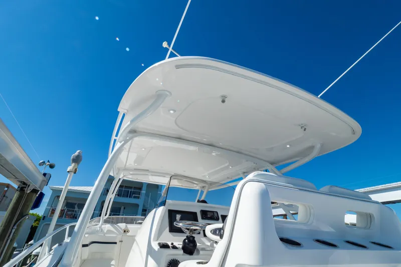 Slide: The Image of 2014 Intrepid 375 Walkaround boat helm under clear blue sky. - 53