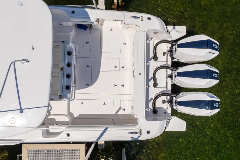 Slide: The Image of Overhead view of 2014 Intrepid 375 Walkaround boat with triple outboard engines. - 63