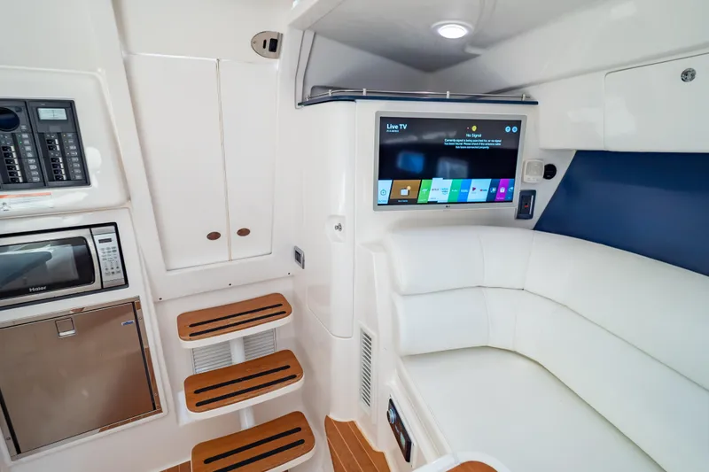Slide: The Image of Interior of 2014 Intrepid 375 Walkaround with TV, microwave, and seating area. - 66