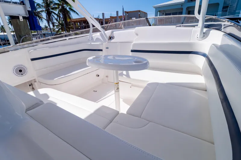 Slide: The Image of Luxurious seating area on a 2014 Intrepid 375 Walkaround boat, featuring white upholstery. - 68