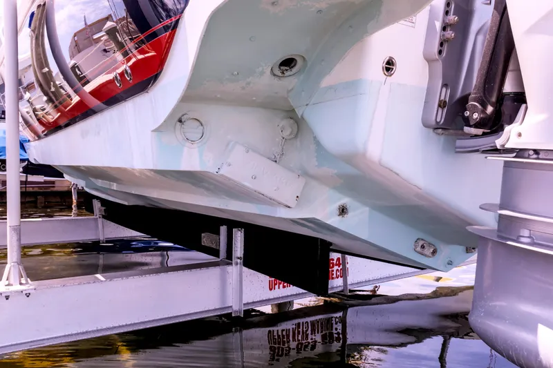 Slide: The Image of 2014 Intrepid 375 Walkaround boat hull on lift, showcasing underside details. - 73
