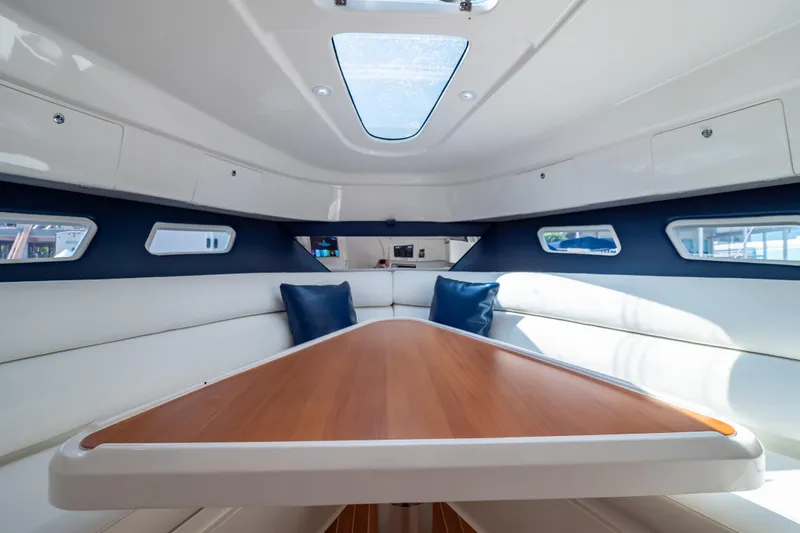 Slide: The Image of Interior of 2014 Intrepid 375 Walkaround boat with sleek seating and wooden table. - 78
