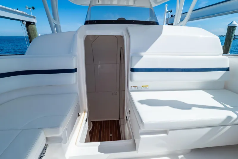 Slide: The Image of 2014 Intrepid 375 Walkaround boat interior with seating and cabin entrance. - 79