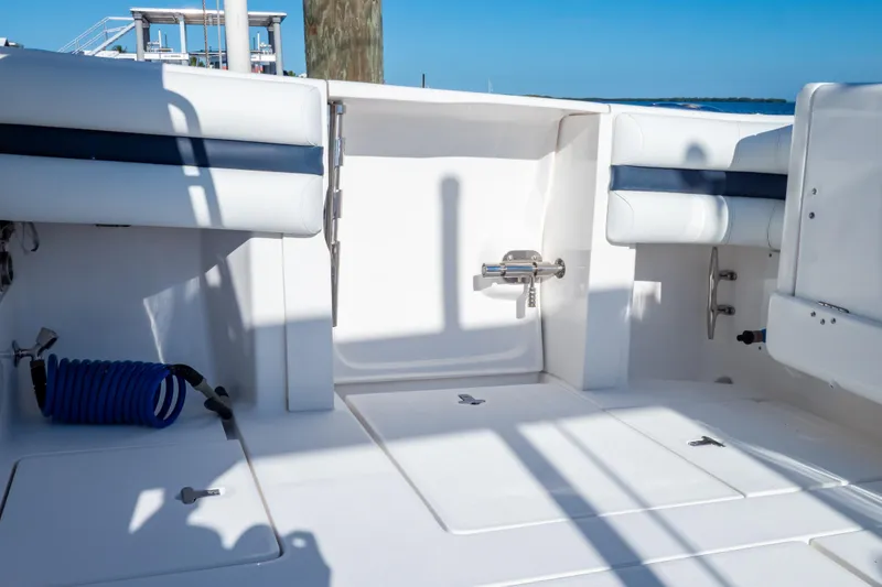 Slide: The Image of 2014 Intrepid 375 Walkaround boat deck with seating and storage compartments. - 85