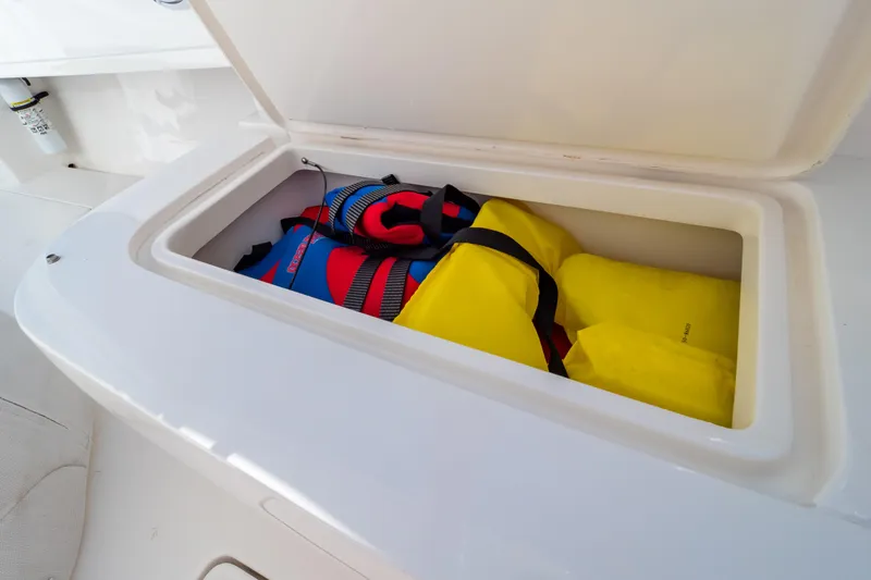 Slide: The Image of Storage compartment with life jackets on a 2014 Intrepid 375 Walkaround boat. - 86