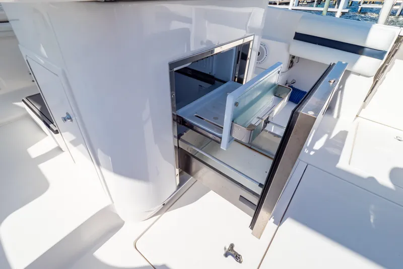 Slide: The Image of 2014 Intrepid 375 Walkaround boat interior with open storage compartments. - 88