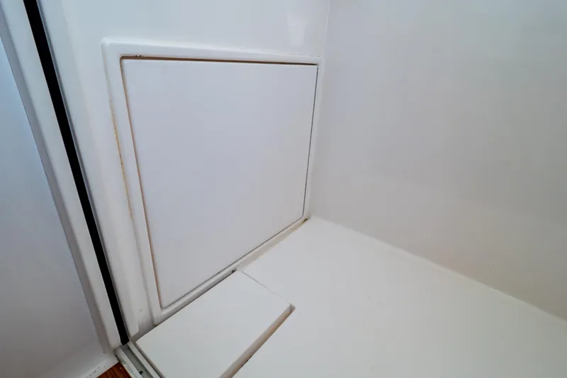 Slide: The Image of Interior compartment of 2014 Intrepid 375 Walkaround boat, featuring a sleek white panel. - 91